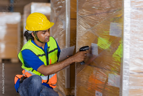 cargo inventory indian worker male working bar code scan check products goods shipping