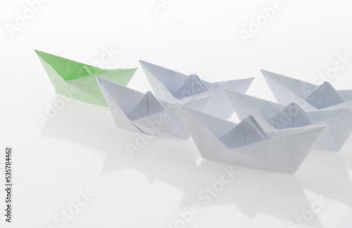The green origami boat is leader