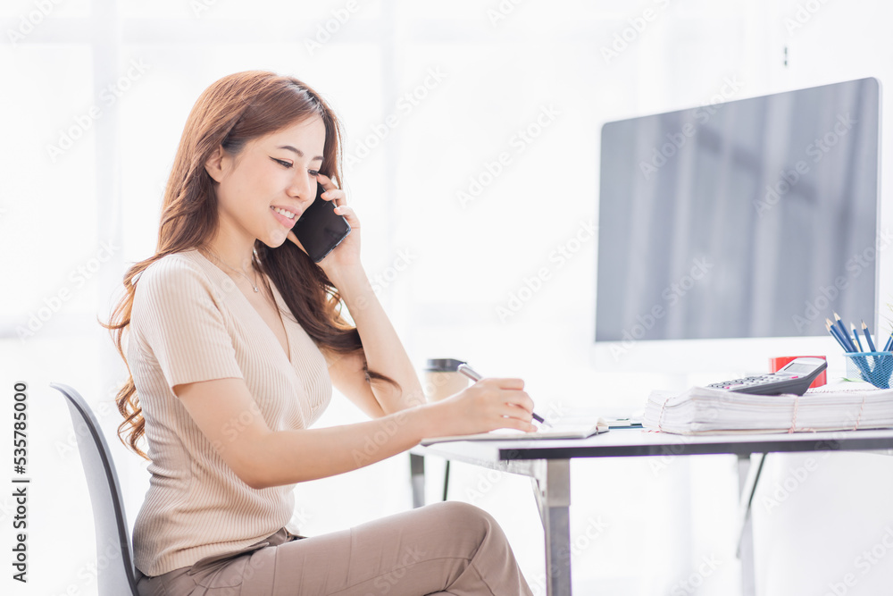 Freelance Smiling young asian business woman using computer laptop working at home Office, Happy business asian woman talking on mobile phone while analyzing weekly schedule in her notebook.
Freelance Smiling young asian business woman using computer laptop working at home Office, Happy business asian woman talking on mobile phone while analyzing weekly schedule in her notebook.