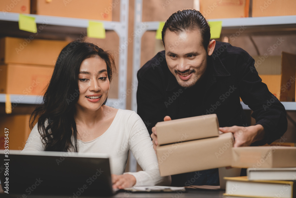 Obraz premium Asian woman e-business entrepreneur checking order and packing parcel box of product shipping delivery business, freelance marketing owner having online cyberspace to work with logistic package job