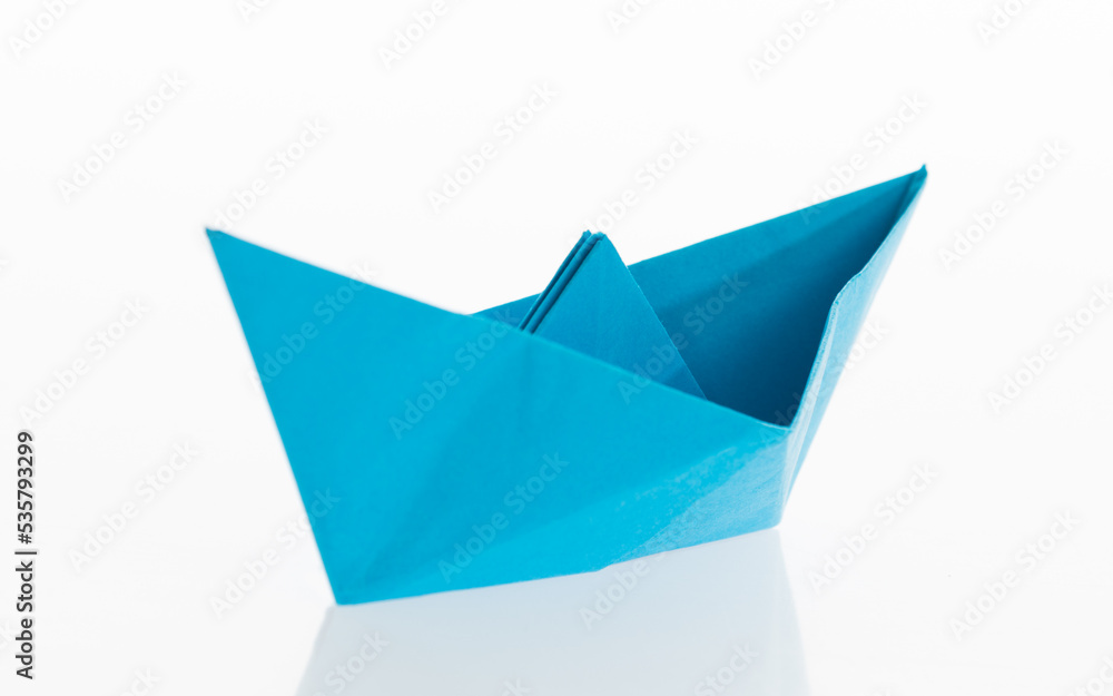 Blue origami boat on white background Blue origami boat on white background