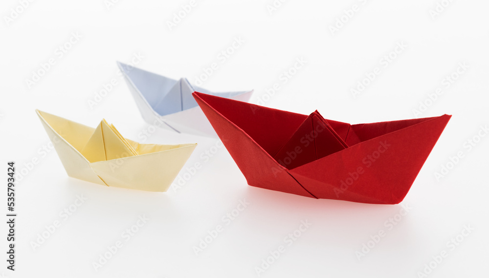 The red origami boat is leader The red origami boat is leader