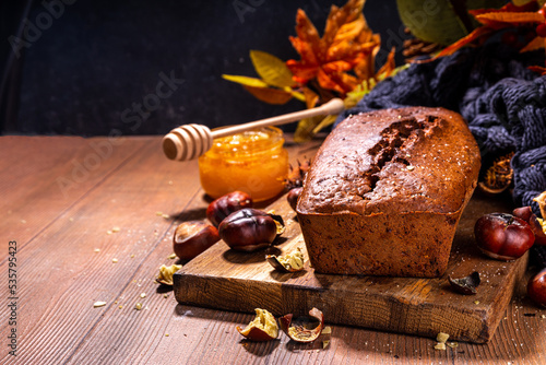 Homemade chestnut cake, sweet vegan chocolate chestnut brownie bread with honey and caramel sauce photo