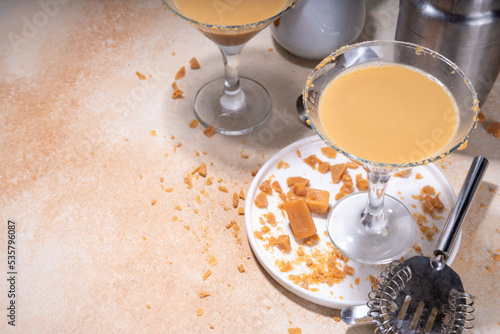 Salted caramel creamy martini drink. Sweet and salty caramel cocktail, with toffee candies, copy space photo