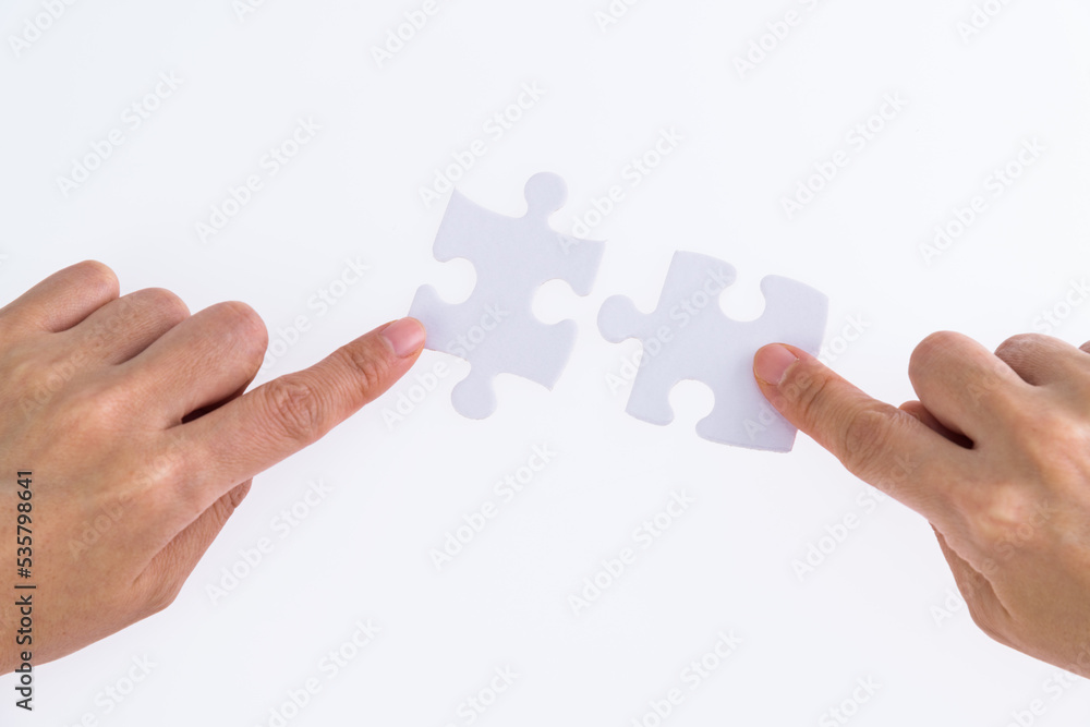 People hand connect two couple puzzle pieces People hand connect two couple puzzle pieces