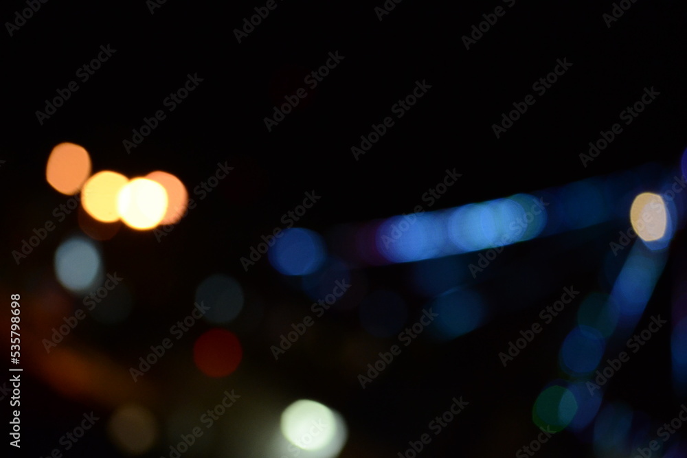 Fototapeta premium Abstract backgrounds. blur bokeh. Blurry multicolor light from the lamp. blue is the dominant color