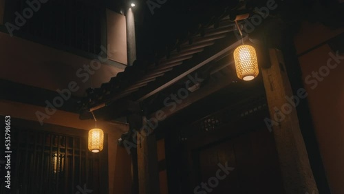 Traditional Chinese lanterns hanging at entrance to house, night scene. Static photo