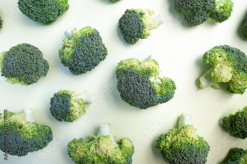 Broccoli inflorescences close-up, green fresh cabbage, Pattern of broccoli inflorescences on a yellow background