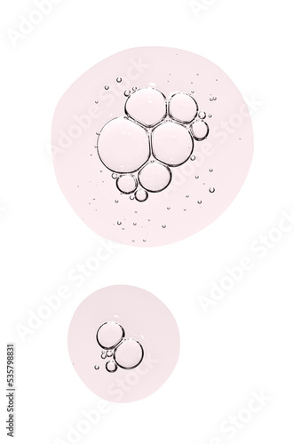 Drops of body serum or cosmetic oil with bubbles. Liquid skin care product. Isolated on a white background.