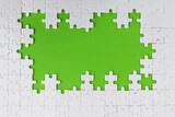 Pieces of jigsaw puzzle on green background
