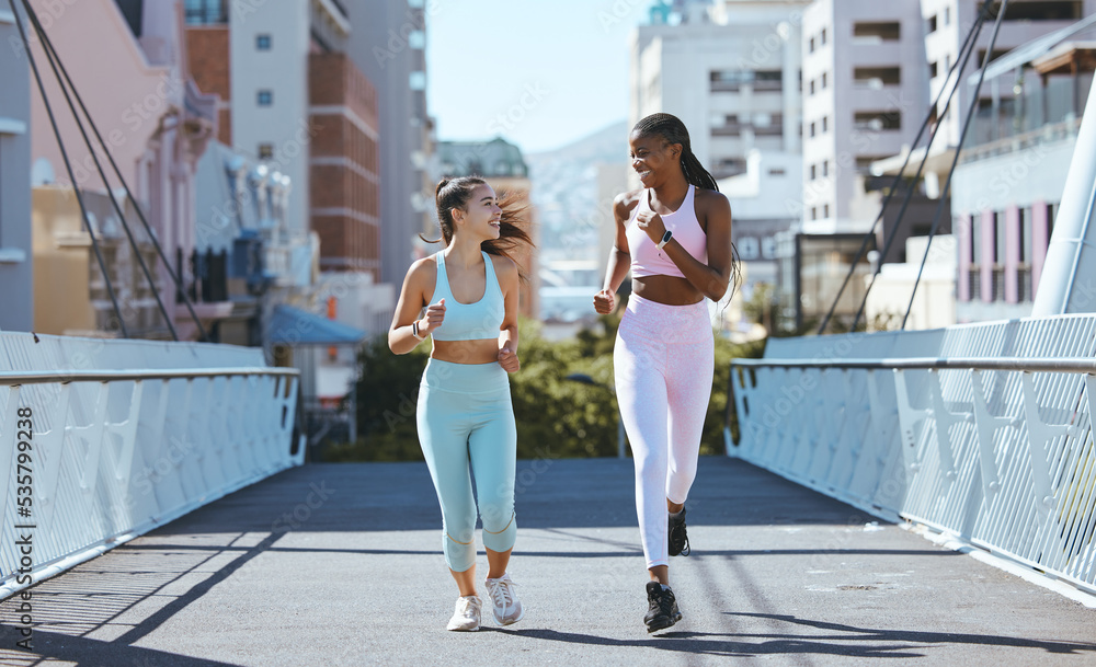 Health women and friends running on bridge in city together for workout and exercise lifestyle. Girl friendship with young, happy and athletic people enjoying cardio fitness run in urban town.