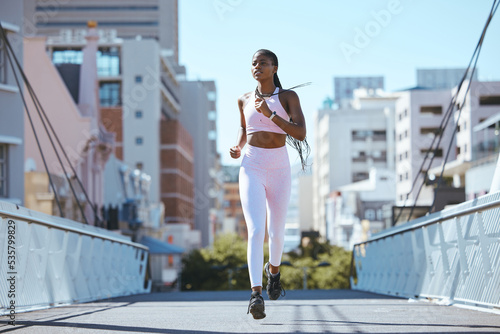Fotografía Exercise workout of black woman running for health and fitness across city bridge