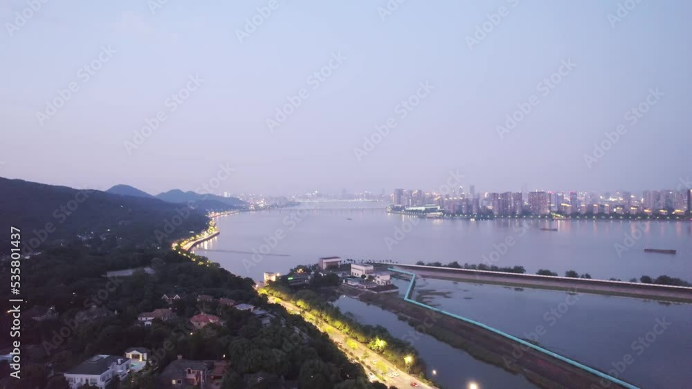 aerial view of modern cityscape of hangzhou along qiantang river at twilight aerial view of modern cityscape of hangzhou along qiantang river at twilight