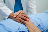 Doctor holding hands Asian elderly woman patient, help and care in hospital.