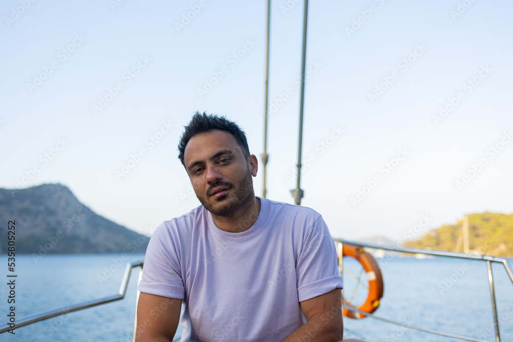 Handsome strong man sailing with his boat. Handsome strong man sailing with his boat.
