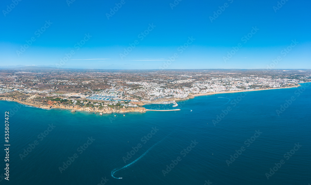 Panoramic view of Albufeira city. Perspective from above. Situated in South of Portugal is a famous travel destination. Beautiful Portuguese landscape with high rocky shore and luxury houses on top. 