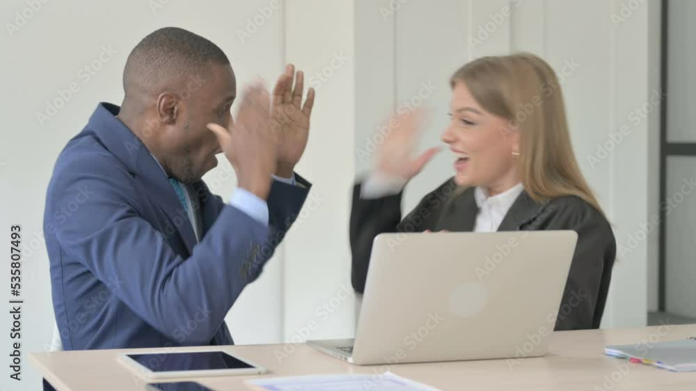 Multiethnic Young Business People Celebrating Success at Work Multiethnic Young Business People Celebrating Success at Work
