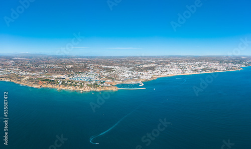 Panoramic view of Albufeira city. Perspective from above. Situated in South of Portugal is a famous travel destination. Beautiful Portuguese landscape with high rocky shore and luxury houses on top.  © alexemarcel