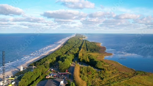 Aerial view of idyllic coastline with sandy beach, green forest and blue Baltic Sea in Wladyslawowo,Poland at sunset  photo