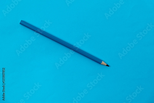 Blue color pencil on blue background
