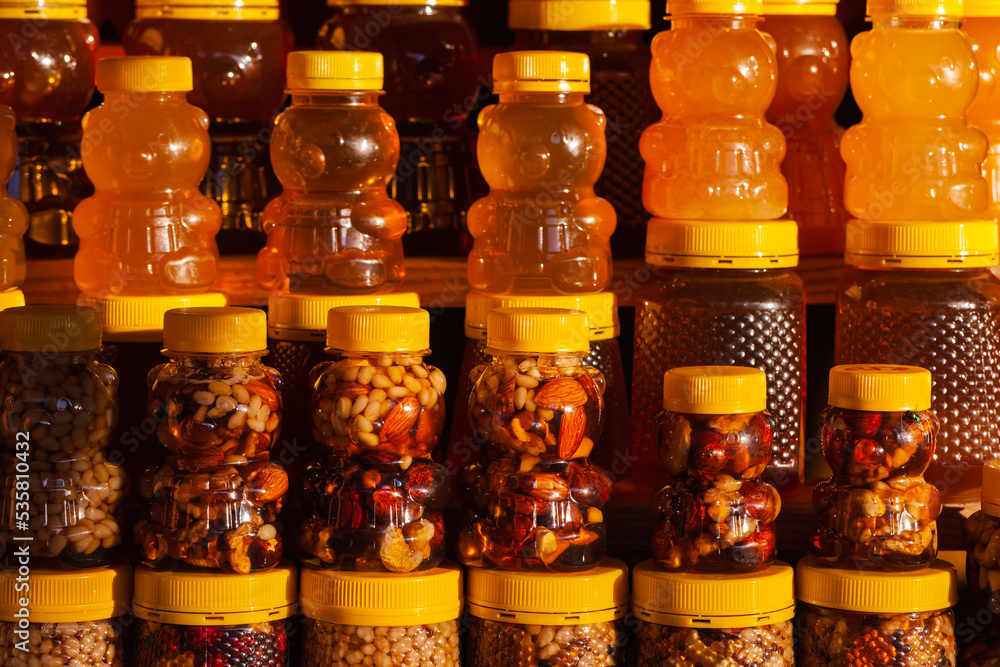 Assortment of honey with nuts in bear shaped plastic jars Assortment of honey with nuts in bear shaped plastic jars