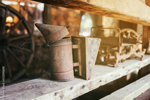 Vintage metal mechanical beekeeping smoker a sunny day