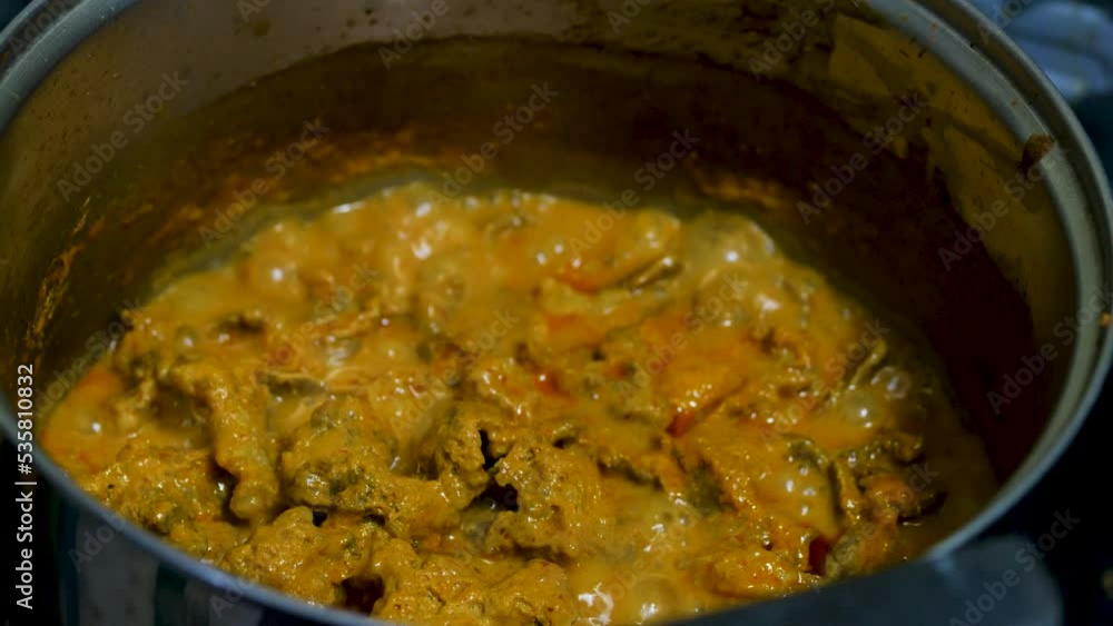 Red curry boiling on a pot with eggpalnt and herb. Making of red curry with chicken, Thai food, Pa neang. Red curry boiling on a pot with eggpalnt and herb. Making of red curry with chicken, Thai food, Pa neang.