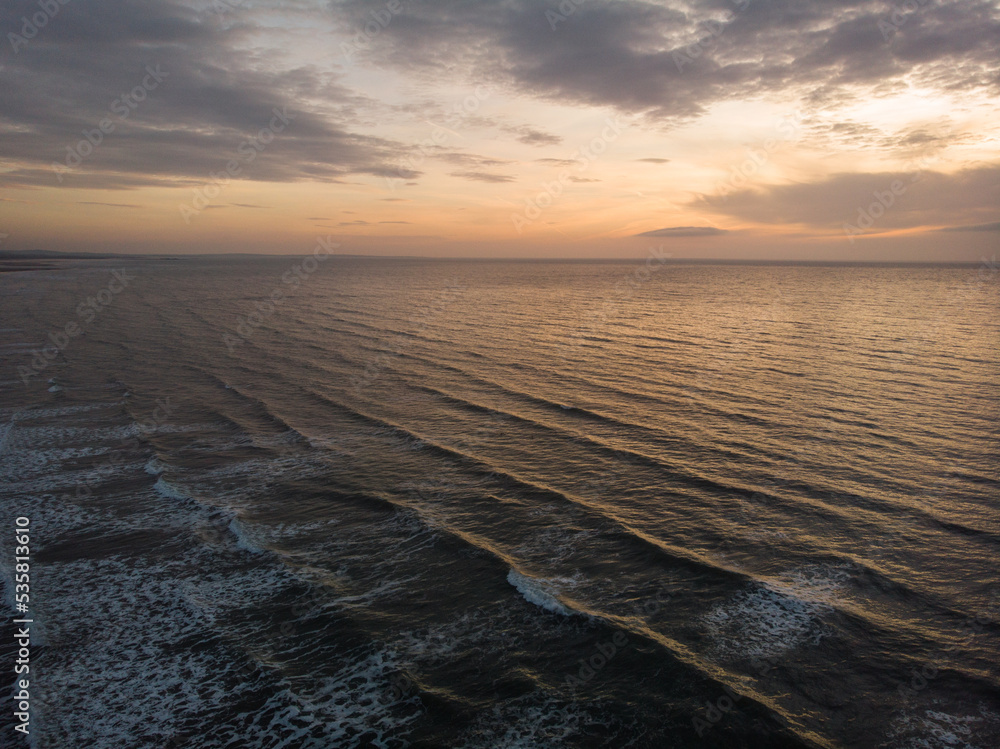 Waves of Irish Sea from Murlough Beach at sunset