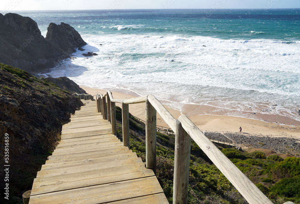 wooden stairs leading down to praia do vale dos homens in the Algarve