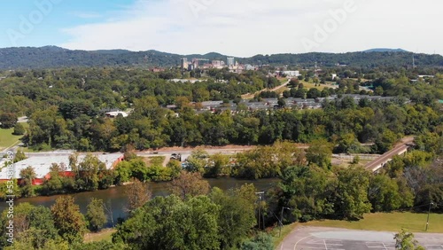 4K Drone Video (truck shot) of French Broad River next to Downtown Asheville, NC viewed from the Westgate Area on Sunny Summer Day - 05 photo