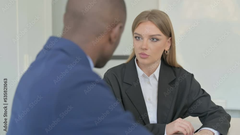 Caucasian Businesswoman Talking with African Businessman
