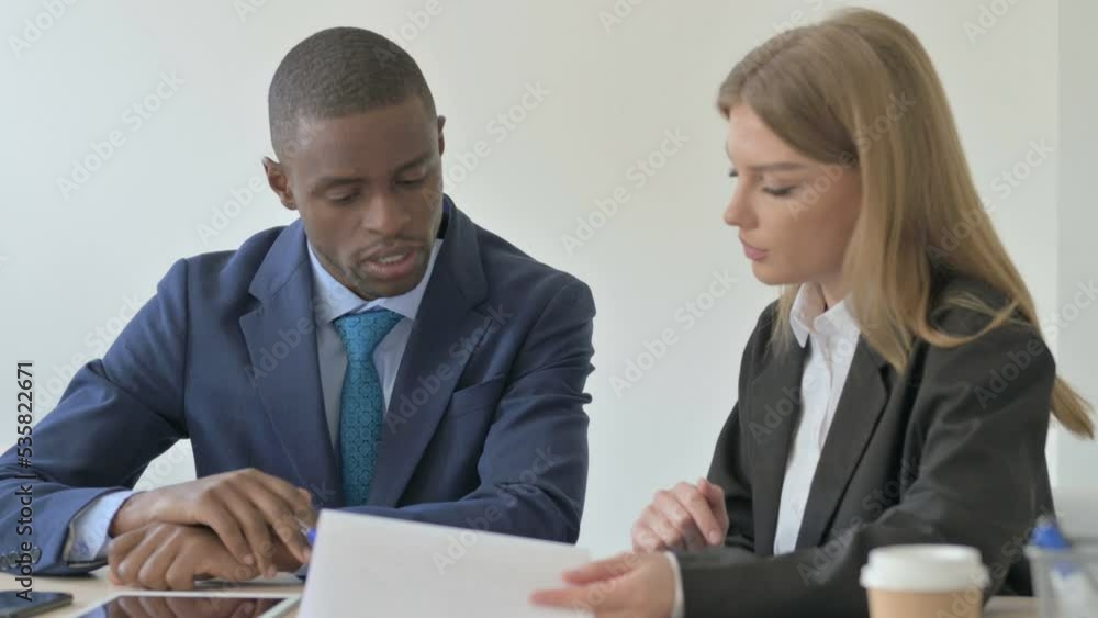 Mixed Race Young Business People Discussing Work, Paperwork Mixed Race Young Business People Discussing Work, Paperwork