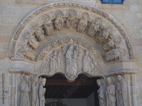 entrance to the college of san jeronimo de santiago de compostela, iconography of santiago apostol, saints and apostles in the columns and arch, tympanum with the virgin and child and saints catalina 