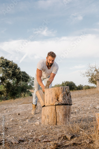 Man cutting wood on farm
