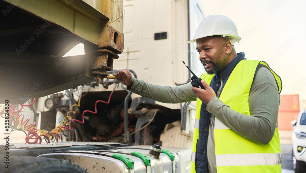 Man, smile and work in logistics with radio in hand for communication while load container on truck at port. Black man, talking and helmet working in shipping, cargo and transportation in Cape Town Man, smile and work in logistics with radio in hand for communication while load container on truck at port. Black man, talking and helmet working in shipping, cargo and transportation in Cape Town