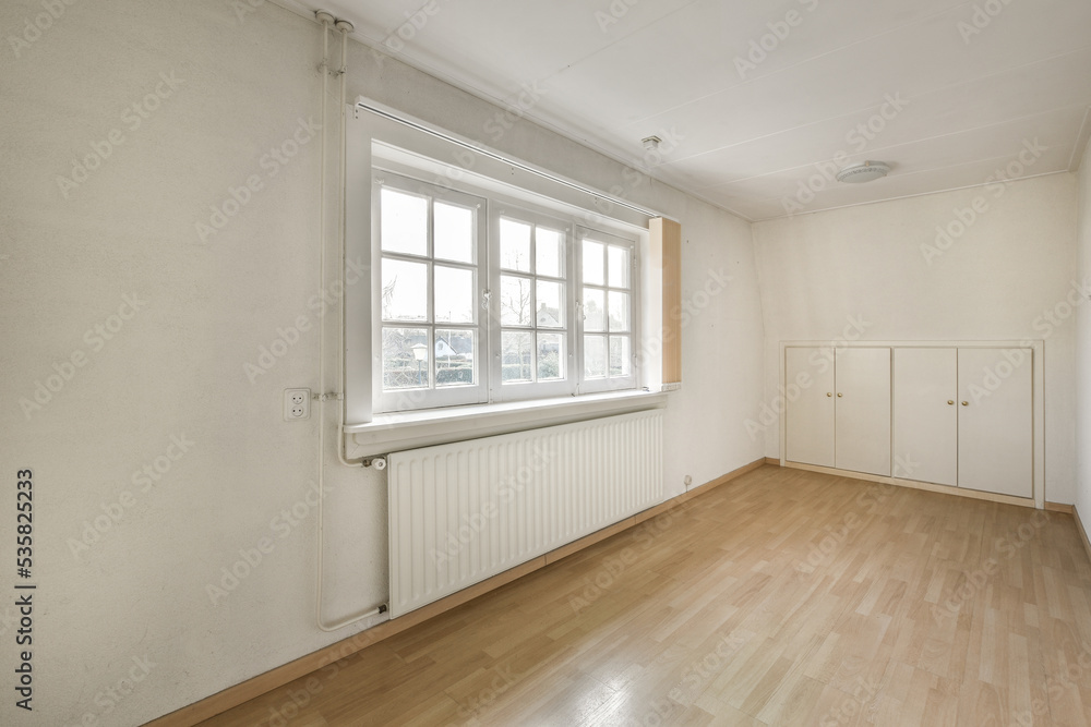 Empty room with window and radiator Empty room with window and radiator