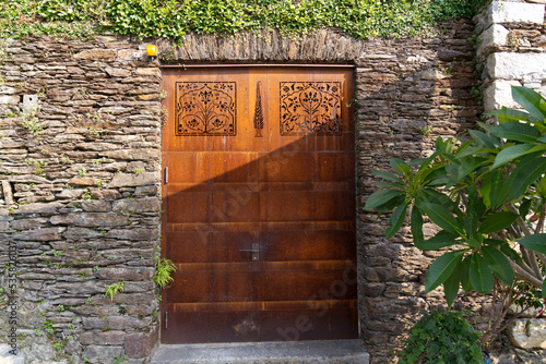 Rusty iron metal gate with ornaments at Brisago Islands, Canton Ticino, on a sunny summer day. Photo taken July 25th, 2022, Brisago Islands, Switzerland. photo