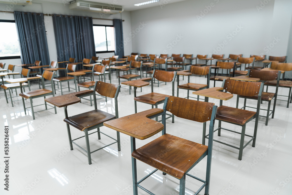 School classroom with many wooden chairs well-arranged in rows with no student