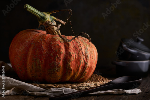 Whole pumpkin on wooden table photo