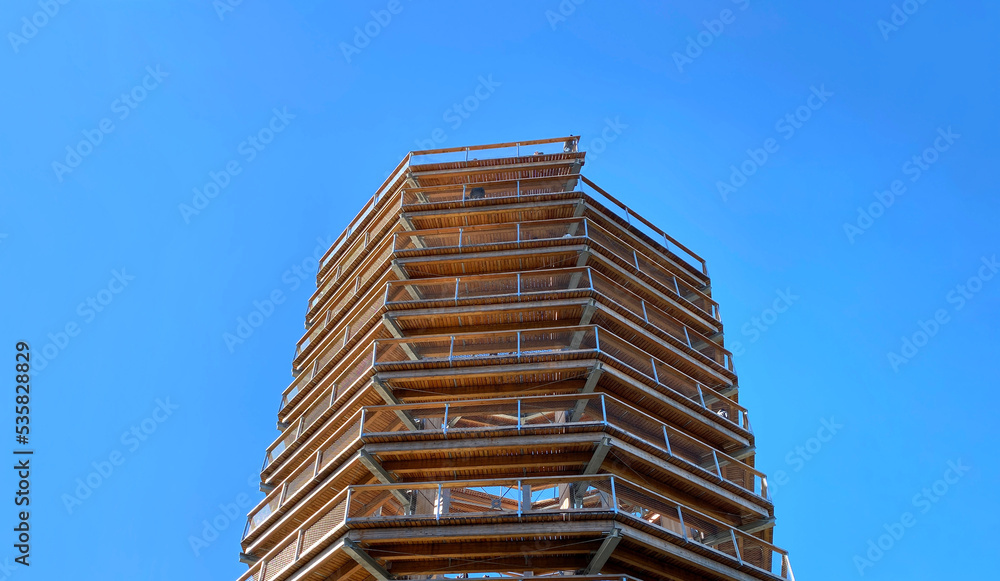 Panoramic tower in the forest. Footbridge and observation tower, view of mountains at fall. High platform, summit path, wooden bridge in the park. Walking in the treetops. Panoramic tower in the forest. Footbridge and observation tower, view of mountains at fall. High platform, summit path, wooden bridge in the park. Walking in the treetops.