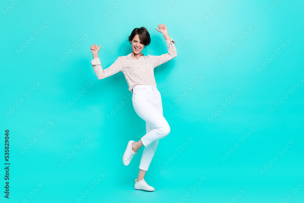 Full length photo of positive satisfied lady rejoice celebrate success achievement sale dance empty space isolated on cyan color background Full length photo of positive satisfied lady rejoice celebrate success achievement sale dance empty space isolated on cyan color background
