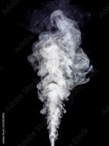 White fluffy smoke swirls and spinning on black
