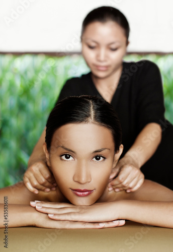 Woman receiving oil massage at a spa, Bali, Indonesia. photo