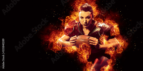 Fototapeta Naklejka Na Ścianę i Meble -  Burning American football player woman on dark background with space for text