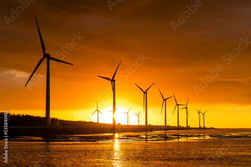 Sunset view of Gaomei wetlands landscape and the wind power plant in Taichung, Taiwan. energy systems and renewable energy. photo