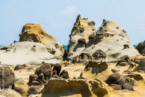 The landscape of the coastal rock at Heping Island Park in Keelung City, Taiwan, Keelung Islet is just in the back. photo