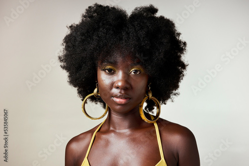 Beauty yellow makeup or black woman portrait of model with fashion, facial makeup or hair care with designer jewelry. Trendy, face cosmetics art or edgy girl from Nigeria in white background