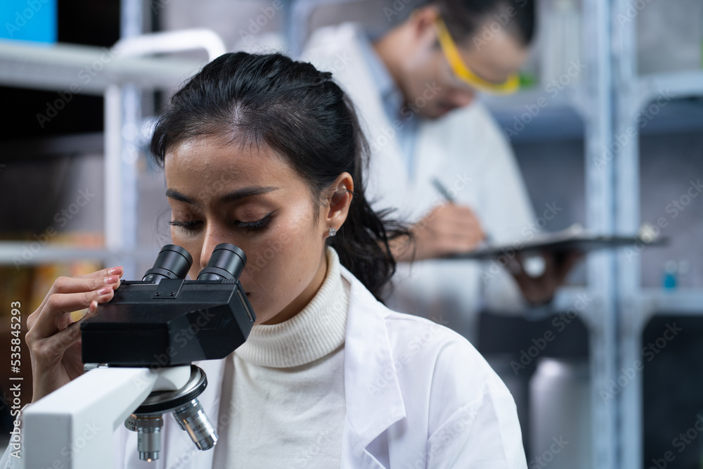 Medical Science Laboratory Looking Under Microscope Analysis of Test Biotechnology working with Advanced Equipment