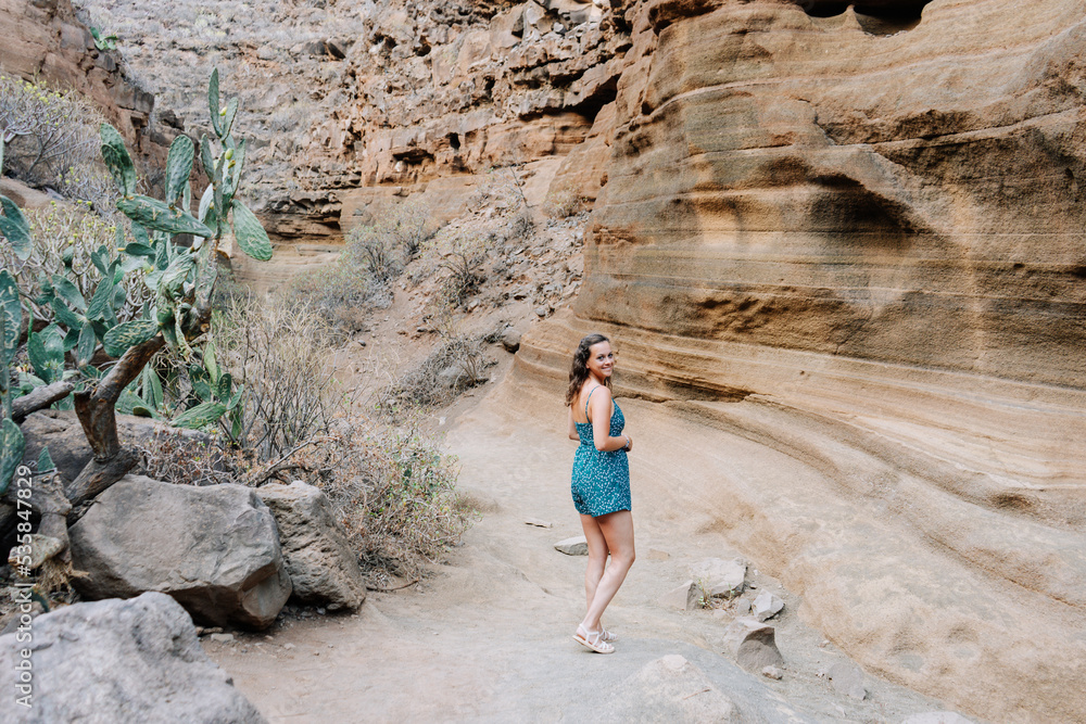 Woman walking by a dried canyon