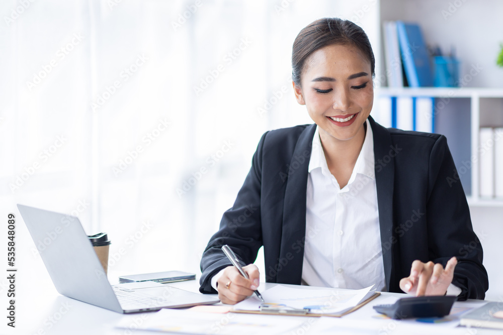 Asian female accountant or banker making calculations. Young business asian woman in workplace, Documents, tax, report for analysis Savings, finances and economy concept. Asian female accountant or banker making calculations. Young business asian woman in workplace, Documents, tax, report for analysis Savings, finances and economy concept.
